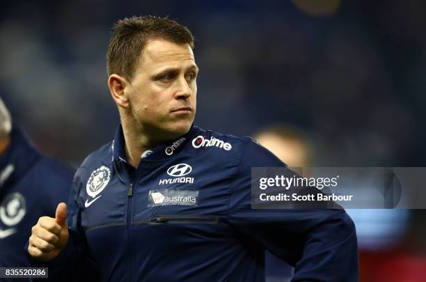 Blues head coach Brendon Bolton speaks to his team during a quarter time break during the round 22 AFL match between the Carlton Blues and the...