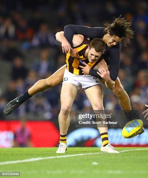 Blake Hardwick of the Hawks is tackled by Jack Silvagni of the Blues during the round 22 AFL match between the Carlton Blues and the Hawthorn Hawks...