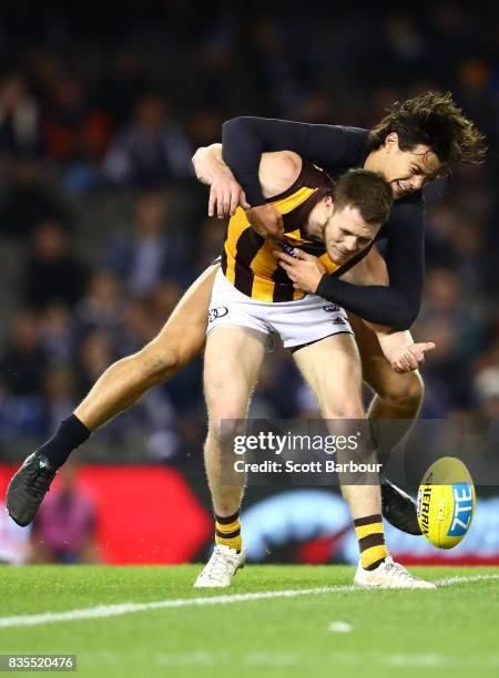 Blake Hardwick of the Hawks is tackled by Jack Silvagni of the Blues during the round 22 AFL match between the Carlton Blues and the Hawthorn Hawks...