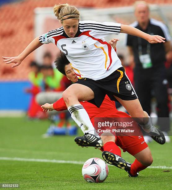 Carolin Simon of Germany takes the ball past the tackle of Kim Un Ju of Korea DPR during the FIFA U-17 Women's World Cup match between Germany and...