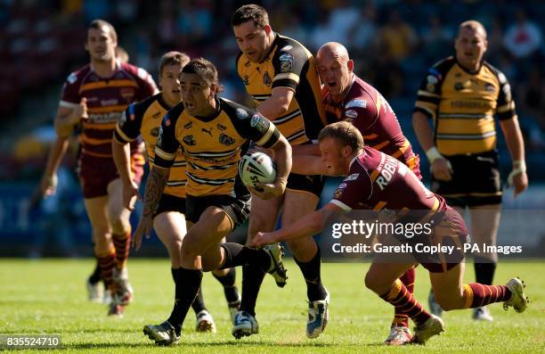 Castleford's Rangi Chase jumps from the tackle of Huddersfield's Luke Robinson during the Carnegie Challenge Cup Quarter Final match at the Galpharm...