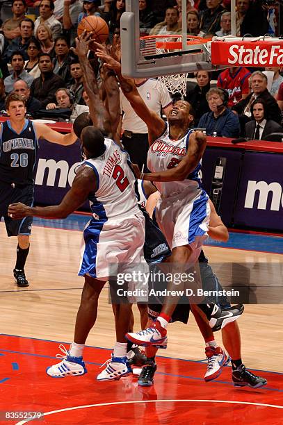 Tim Thomas and Marcus Camby of the Los Angeles Clippers rise for a block against the Utah Jazz at Staples Center on November 3, 2008 in Los Angeles,...