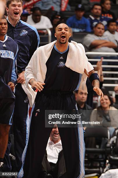 Carlos Boozer of the Utah Jazz cheers his team on from the bench against the Los Angeles Clippers at Staples Center on November 3, 2008 in Los...