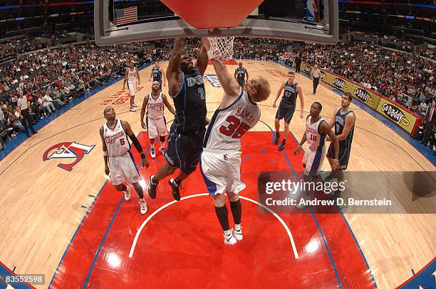 Paul Millsap of the Utah Jazz dunks against Chris Kaman of the Los Angeles Clippers at Staples Center on November 3, 2008 in Los Angeles, California....