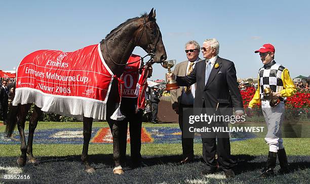 Winning trainer Bart Cummings , foreman Reg Fleming and jockey Blake Shinn celebrate with Australian horse "Viewed" after it defeated English horse...