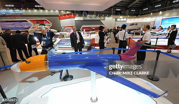 Visitors look at a model of China's ARJ21 at the China Airshow 2008 in the southern Chinese city of Zhuhai on November 4, 2008. The 7th International...