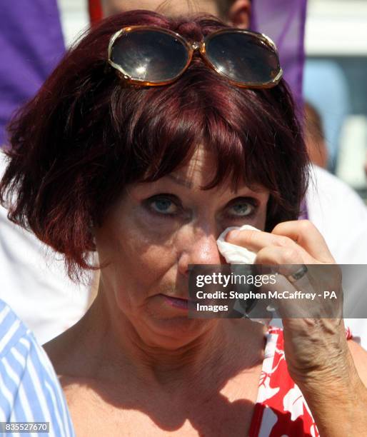 Protester wipes away a tear during a rally at the City Hall in Belfast today.