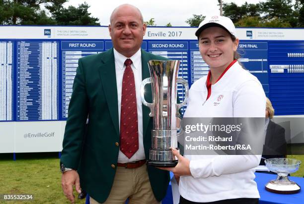 Lily May Humphreys of England is presented with the trophy following her victory during the final of the Girls' British Open Amateur Championship at...