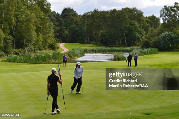 Lily May Humphreys of England celebrates holing a putt on the 16th green during her semi-final match against Paula Kimer of Germany during the Girls'...