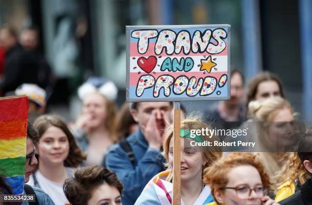 Participant holds a sign saying "Trans and Proud" during the Glasgow Pride march on August 19, 2017 in Glasgow, Scotland. The largest festival of...