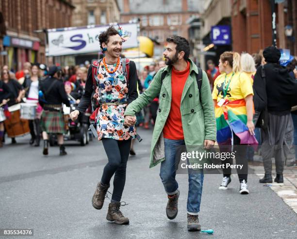 Participants hold hands during the Glasgow Pride march on August 19, 2017 in Glasgow, Scotland. The largest festival of LGBTI celebration in Scotland...