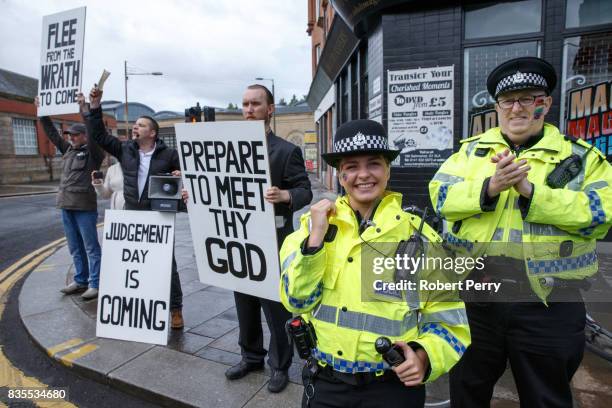 Police gesture during the Glasgow Pride march on August 19, 2017 in Glasgow, Scotland. The largest festival of LGBTI celebration in Scotland has been...