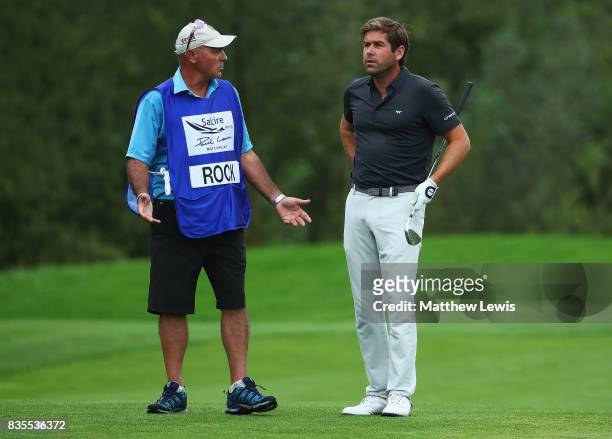 Robert Rock of England looks on with his caddie on the 16th fairway during day three of the Saltire Energy Paul Lawrie Matchplay at Golf Resort Bad...
