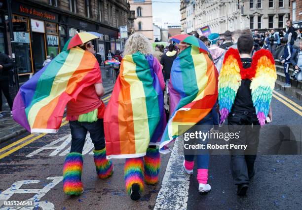 Participants wear rainbow flags and angel winfs during the Glasgow Pride march on August 19, 2017 in Glasgow, Scotland. The largest festival of LGBTI...