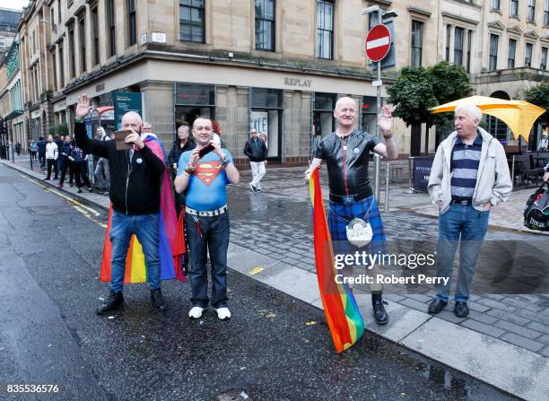 Participants wave during the Glasgow Pride march on August 19, 2017 in Glasgow, Scotland. The largest festival of LGBTI celebration in Scotland has...