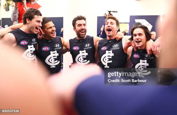 Sam Petrevski-Seton of the Blues and his teammates sing the song in the rooms after winning during the round 22 AFL match between the Carlton Blues...