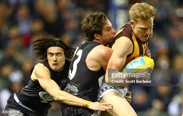 Jed Lamb of the Blues tackles James Sicily of the Hawks during the round 22 AFL match between the Carlton Blues and the Hawthorn Hawks at Etihad...
