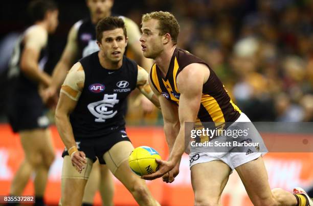 Tom Mitchell of the Hawks runs with the ball during the round 22 AFL match between the Carlton Blues and the Hawthorn Hawks at Etihad Stadium on...