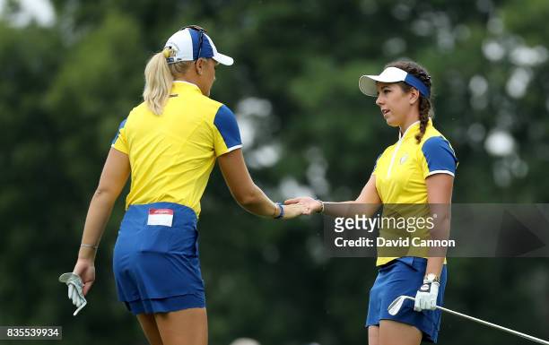 Georgia Hall of England and Anna Nordqvist of Sweden and the European Team celebrate on the 16th hole after Hall had holed a crucial putt in their...