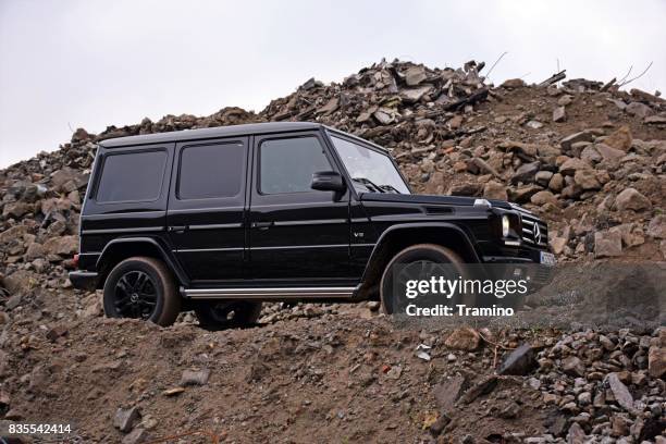 mercedes-benz g500 stopped on the road with rubble - mercedes benz g class stock pictures, royalty-free photos & images