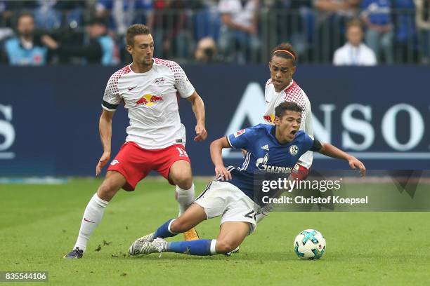 Stefan Ilsanker of Leipzig , Amine Harit of Schalke and Yussuf Poulsen of Leipzig during the Bundesliga match between FC Schalke 04 and RB Leipzig at...