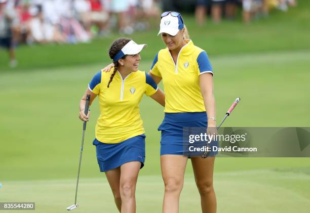 Georgia Hall of England and Anna Nordqvist of Sweden and the European Team celebrate on the 16th hole after Hall had holed a crucial putt in their...