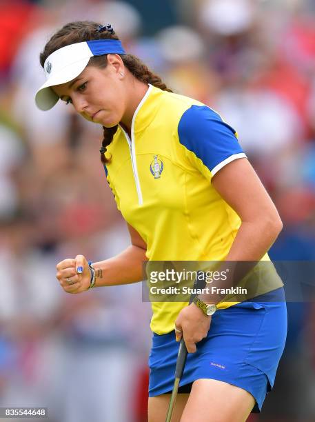 Georgia Hall of Team Europe celebrates holeing a putt during the second day morning foursomes matches of The Solheim Cup at Des Moines Golf and...