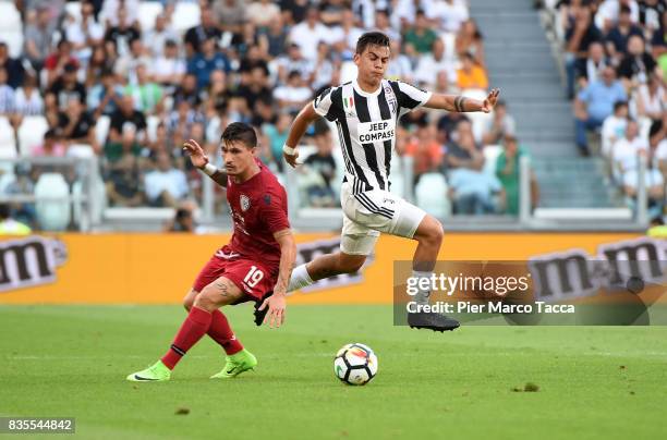 Fabio Pisacane of Cagliari Calcio competes for the ball with Paulo Dybala of Juventus during the Serie A match between Juventus and Cagliari Calcio...