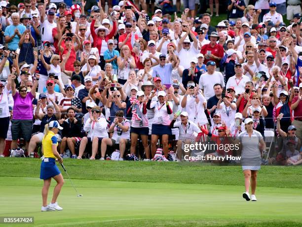 Cristie Kerr of Team USA celebrates her putt to win five and three in front of Jodi Ewart Shadoff of Team Europe on the 15th green during the morning...