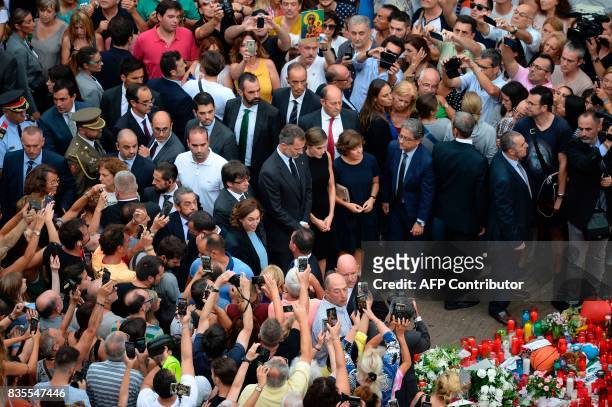 Spain's King Felipe VI and Spain's Queen Letizia pay tribute to the victims of the Barcelona attack on Las Ramblas boulevard, in Barcelona on August...
