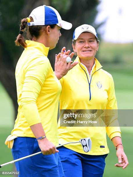 Catriona Matthew of Team Europe celebrates a birdie putt from Karine Icher to win the 12th hole from Team USA during the morning foursomes matches of...