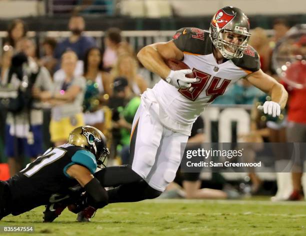 Marqueston Huff of the Tampa Bay Buccaneers is tackled by Tyler Patmon of the Jacksonville Jaguars during a preseason game at EverBank Field on...