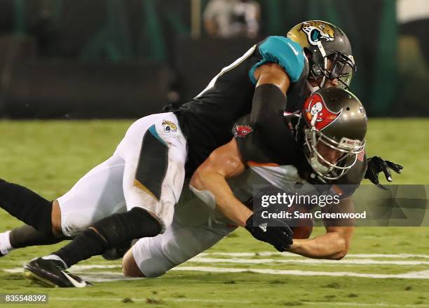 Adam Humphries of the Tampa Bay Buccaneers is tackled byTyler Patmon of the Jacksonville Jaguars during a preseason game at EverBank Field on August...