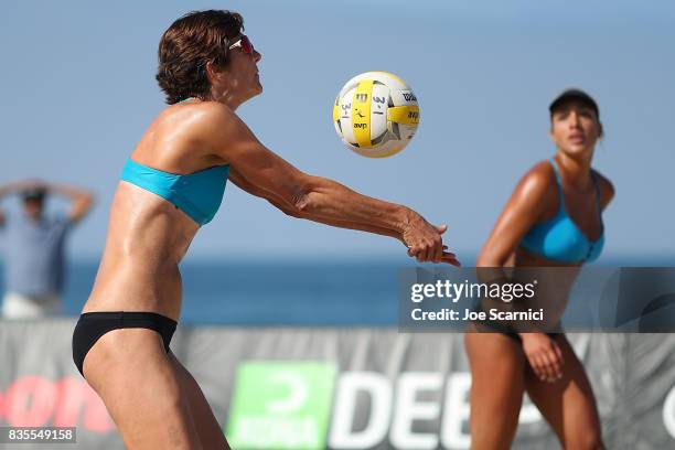 Nicole Branagh sets the ball for Brandie Wilkerson during their round 3 match at the AVP Manhattan Beach Open - Day 3 on August 19, 2017 in Manhattan...