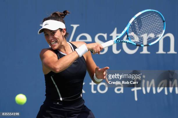 Garbine Muguruza of Spain returns a shot to Karolina Pliskova of Czech Republic during Day 8 of the Western and Southern Open at the Linder Family...