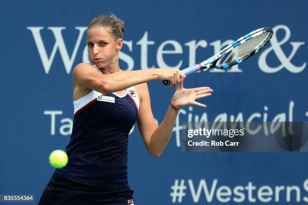 Karolina Pliskova of Czech Republic returns a shot to Garbine Muguruza of Spain during Day 8 of the Western and Southern Open at the Linder Family...