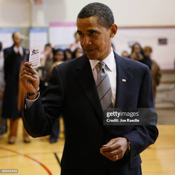 Democratic presidential nominee U.S. Sen. Barack Obama shows off a voter validation slip on election day after voting November 4, 2008 in Chicago,...