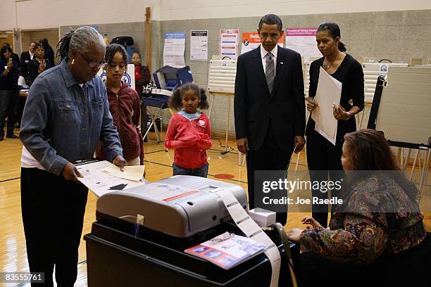 Democratic presidential nominee U.S. Sen. Barack Obama and his wife, Michelle Obama , stand with their daughters, Malia and Sasha as they wait to...