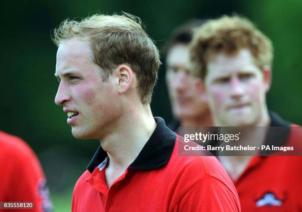Prince William leads Prince Harry towards the presentation area after they had won the Dorchester Trophy playing for Umbogo against Lovelocks at...