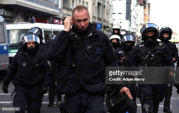 Backup police officers arrive as Neo-Nazis march at an extreme right-wing demonstration commemorating the 30th anniversary of the death of Nazi...