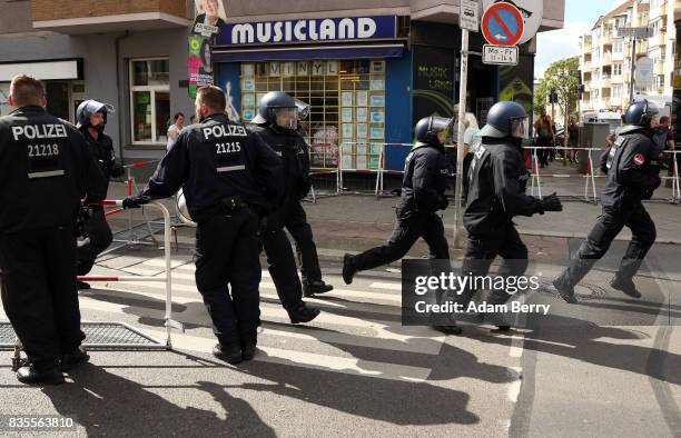 Backup police officers arrive as Neo-Nazis march at an extreme right-wing demonstration commemorating the 30th anniversary of the death of Nazi...
