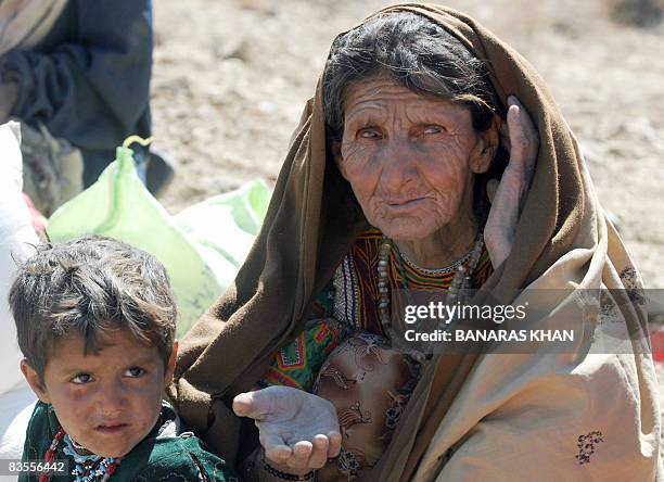 An elderly Pakistani earthquake survivor waits for relief supplies at a hilly area of Killy Kach, one of about eight sparsely populated villages...