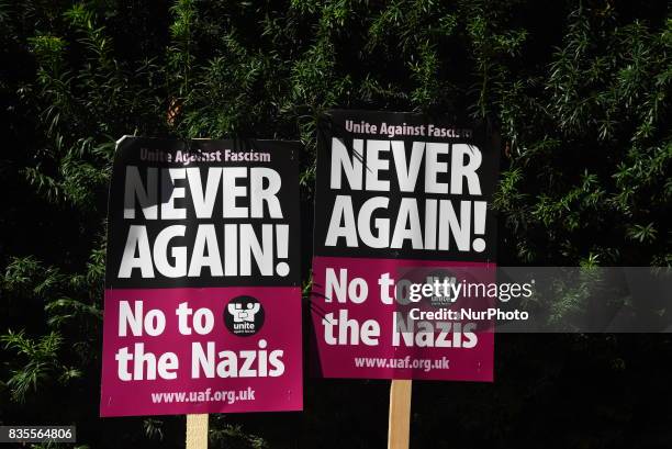 Two placards are seen outside the American Embassy in Central London, at the protest against the racism escalation following the riot in...