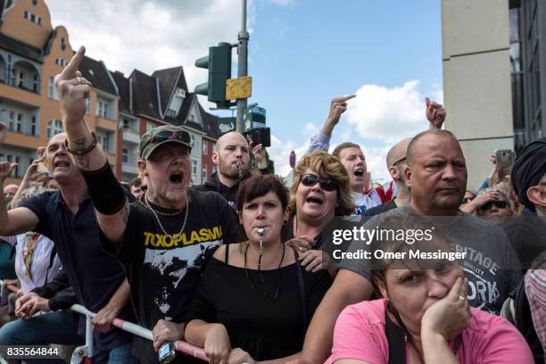 Counter demonstrators gesture and chant slogans towards participants of a Neo-Nazi event, on August 19, 2017 in Berlin, Germany. Some 1000...