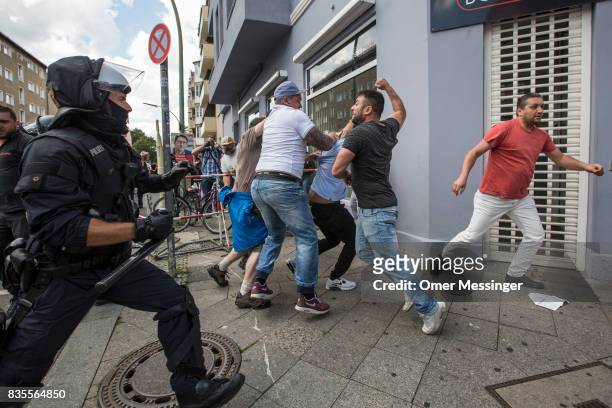 Participants of a Neo-Nazi march clash with counter demonstrators as German police try to break between the sides, on August 19, 2017 in Berlin,...