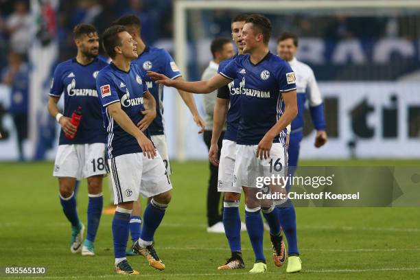 Fabian Reese of Schalke celebrates with Yevhen Konoplyanka of Schalke following their victory during the Bundesliga match between FC Schalke 04 and...