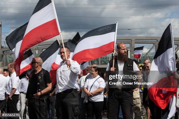 Participants of a Neo-Nazi demonstration are seen holding nationalistic flags at a gathering point prior to an extreme right mass demonstration , on...