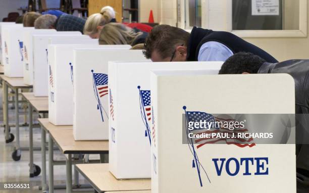 Voters cast their ballots on Election Day November 04 at Centreville High School in Clifton, Virginia. Americans crowded polling stations Tuesday to...