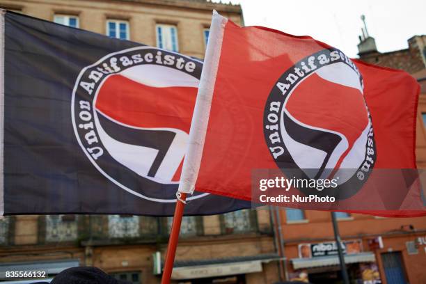 Two antifascism flags during a gathering in Toulouse in solidarity with anti-fascists in Charlottesville after the killing of Heather Heyer by a...