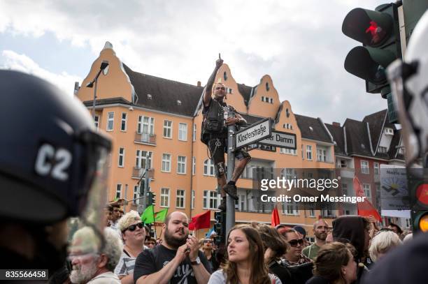 Counter demonstrator gesture and cant slogans towards a gathering of Neo-Nazis at the end of their march, on August 19, 2017 in Berlin, Germany. Some...